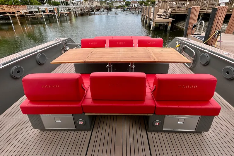 Odessa Mama Yacht Photos Pics 2023 Pardo Yachts 43 with red seating and wooden table on deck.