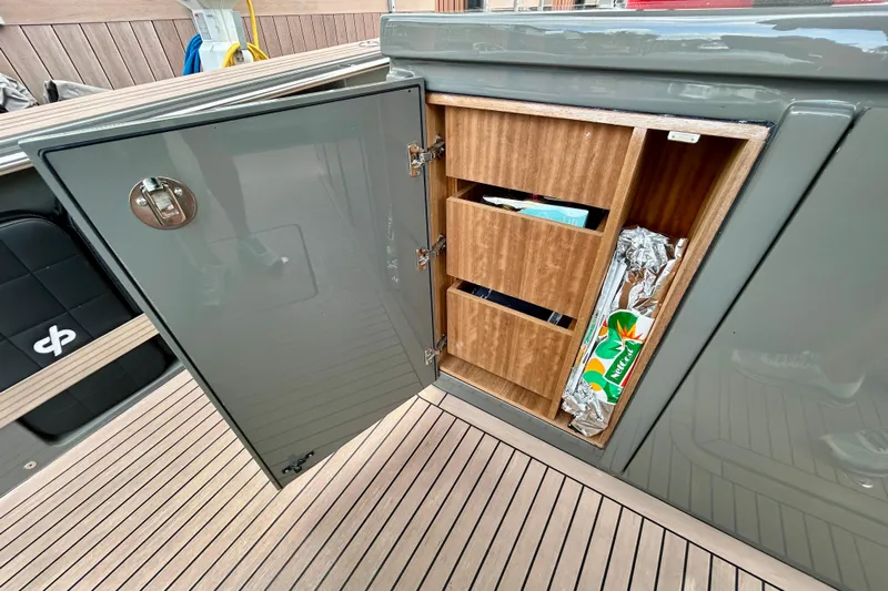 Odessa Mama Yacht Photos Pics Open storage cabinet on 2023 Pardo Yachts 43, featuring wooden shelves and various items.