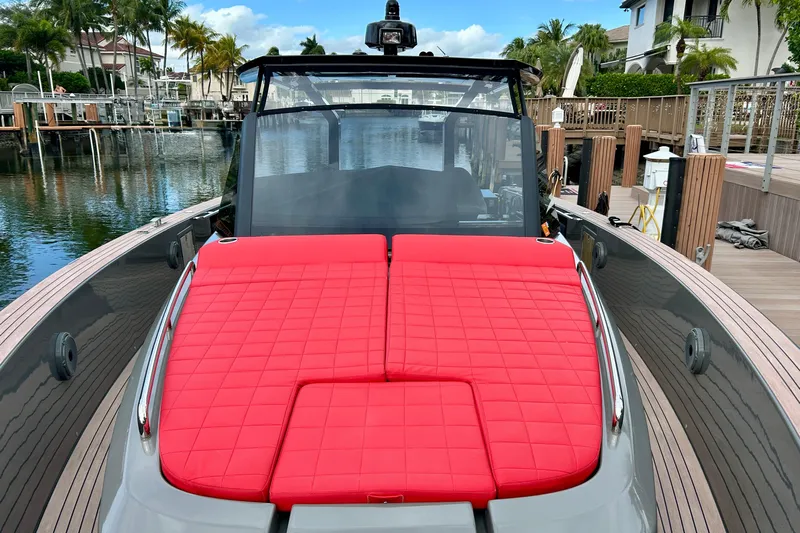 Odessa Mama Yacht Photos Pics 2023 Pardo Yachts 43 with red cushioned deck, docked in a scenic marina.