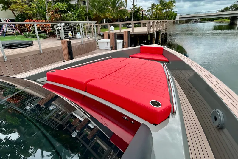Odessa Mama Yacht Photos Pics 2023 Pardo Yachts 43 with vibrant red seating, docked by a scenic waterfront.