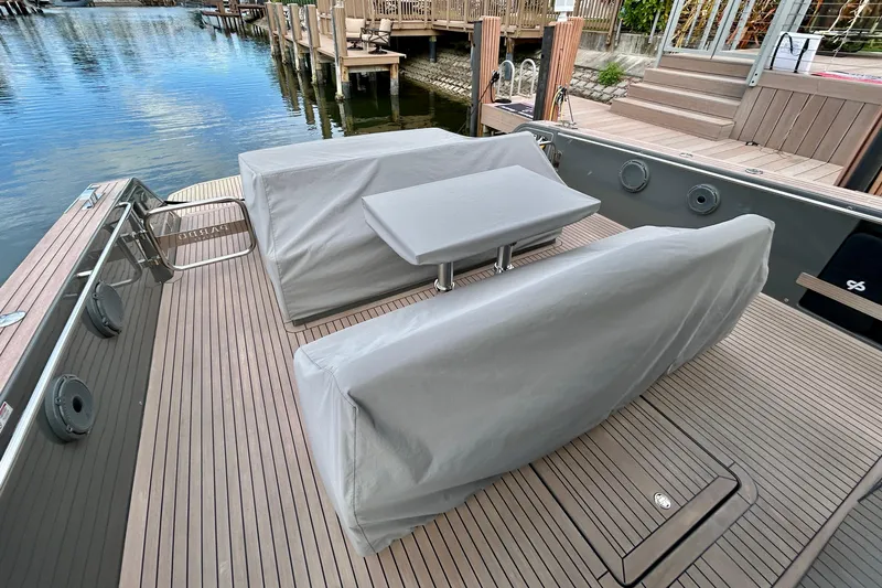 Odessa Mama Yacht Photos Pics 2023 Pardo Yachts 43 deck with covered seating and table by the water.