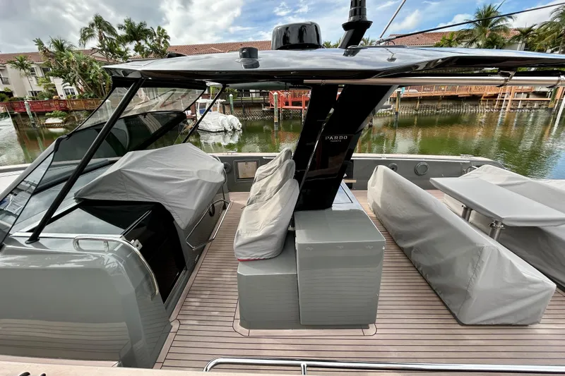 Odessa Mama Yacht Photos Pics 2023 Pardo Yachts 43 with covered seating, docked by a waterfront.