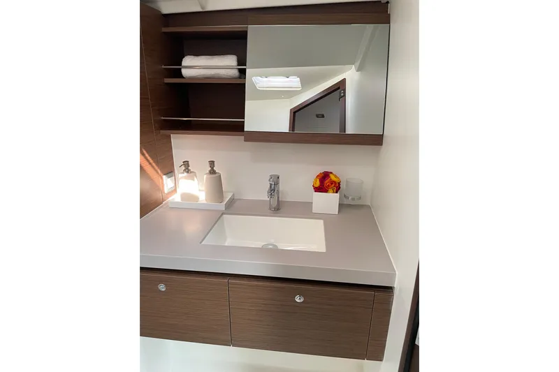 Show Boat! Yacht Photos Pics Modern bathroom vanity in 2024 Beneteau Oceanis 51.1 yacht, featuring sleek design and storage.