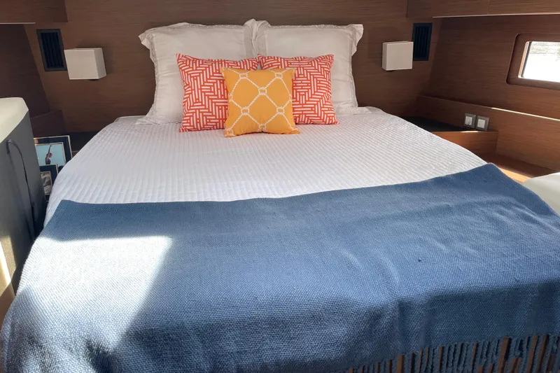 Show Boat! Yacht Photos Pics Luxurious cabin interior of 2024 Beneteau Oceanis 51.1 yacht with stylish bedding.