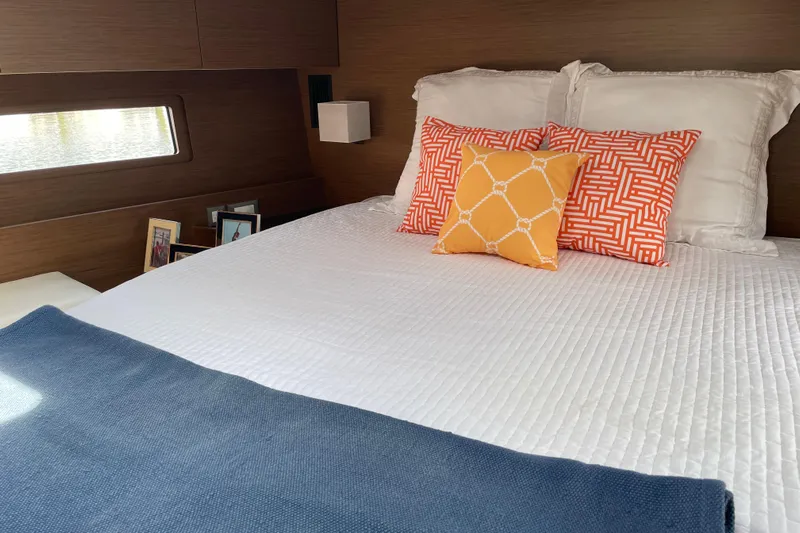 Show Boat! Yacht Photos Pics Luxurious cabin interior of 2024 Beneteau Oceanis 51.1 yacht with stylish bedding.