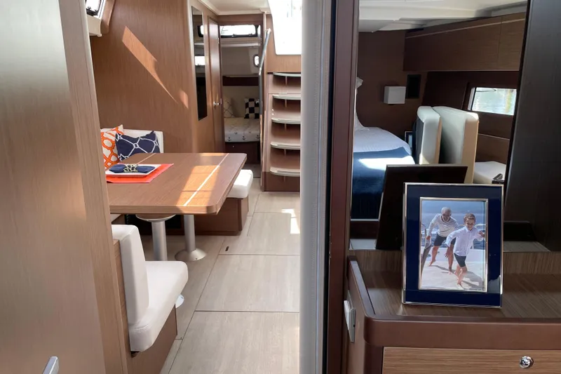 Show Boat! Yacht Photos Pics Interior of 2024 Beneteau Oceanis 51.1 yacht with dining area and cozy cabin.