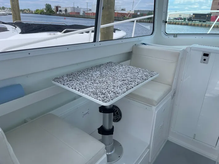  Yacht Photos Pics Interior seating and table of 2021 Steiger Craft 28 DV Chesapeake boat.
