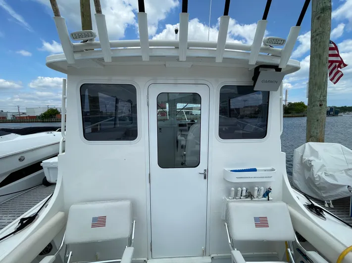  Yacht Photos Pics 2021 Steiger Craft 28 DV Chesapeake boat stern with seating and fishing rod holders.