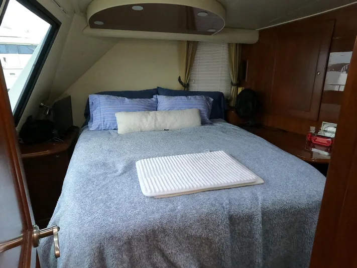  Yacht Photos Pics Luxurious bedroom interior of 2006 Bluewater Yachts 5200 with cozy bedding and elegant decor.