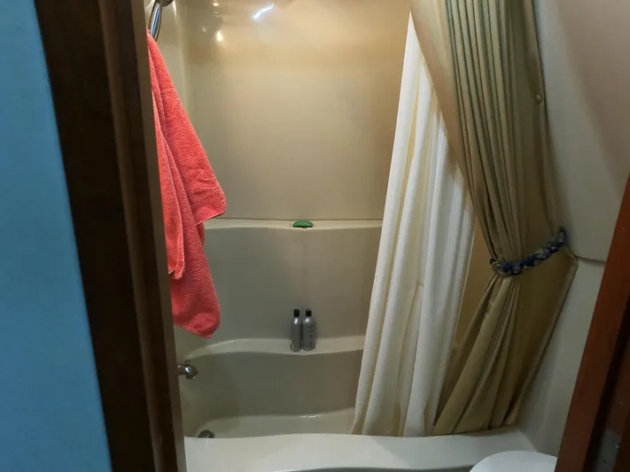  Yacht Photos Pics Bathroom with shower in 2006 Bluewater Yachts 5200, featuring curtain and towel.