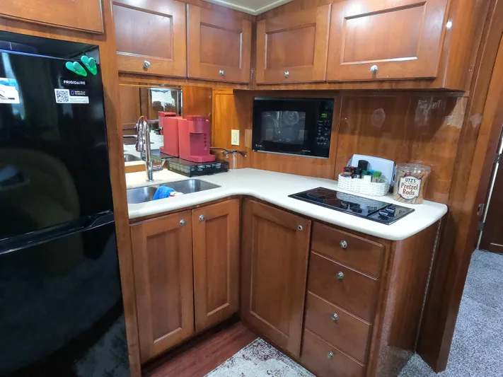  Yacht Photos Pics Kitchen area of 2006 Bluewater Yachts 5200 with wood cabinets and modern appliances.
