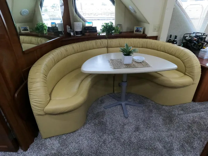  Yacht Photos Pics 2006 Bluewater Yachts 5200 interior with curved seating and table.