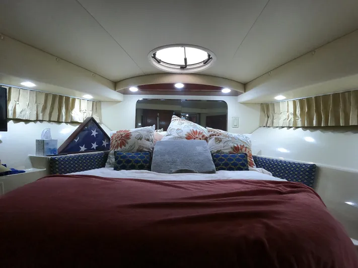 Yacht Photos Pics Cozy bedroom interior of 2006 Bluewater Yachts 5200 with plush bedding and soft lighting.