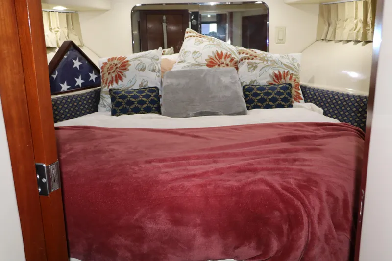 Yacht Photos Pics Cozy bedroom in 2006 Bluewater Yachts 5200 with plush pillows and red blanket.