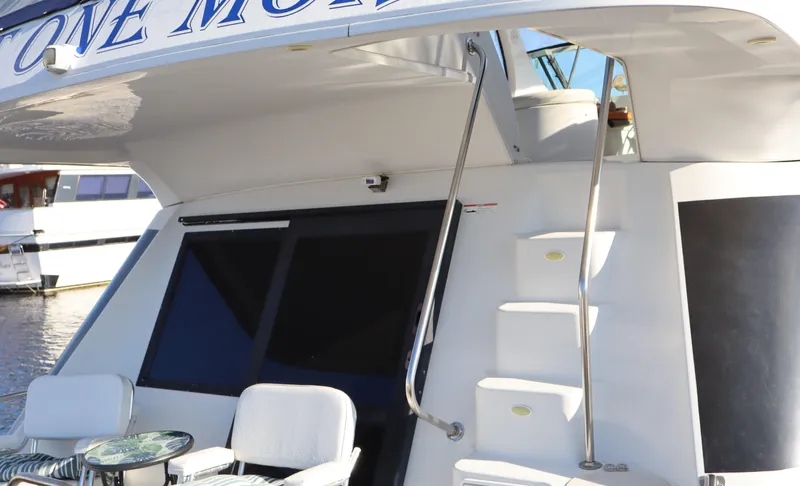  Yacht Photos Pics 2006 Bluewater Yachts 5200, rear view with seating and stairs, docked by the water.