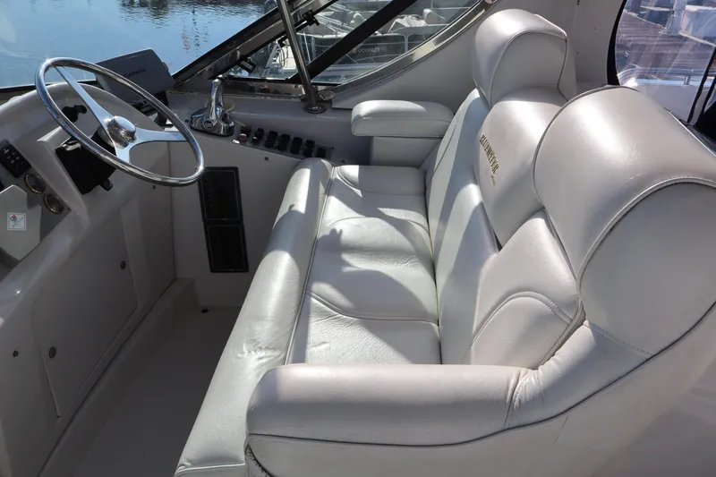  Yacht Photos Pics Luxurious helm seating on 2006 Bluewater Yachts 5200, featuring plush white leather upholstery.