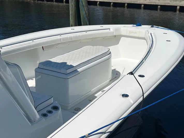Do Dah Yacht Photos Pics 2017 Yellowfin 39 Offshore boat with cushioned seating, docked by the water.