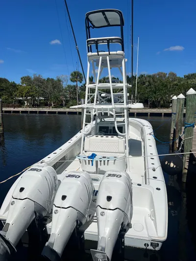 Do Dah Yacht Photos Pics 2017 Yellowfin 39 Offshore boat with triple outboard engines docked by the water.
