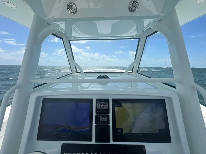Do Dah Yacht Photos Pics 2017 Yellowfin 39 Offshore boat dashboard with navigation screens, ocean view, and clear sky.