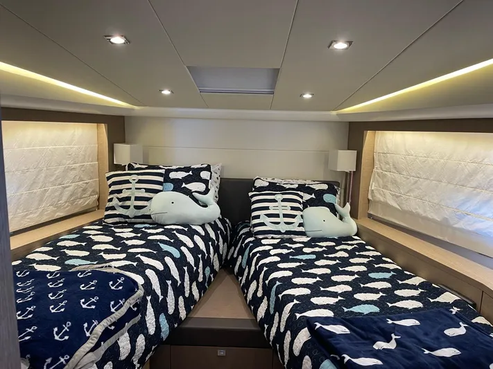  Yacht Photos Pics Twin beds with nautical-themed bedding in a 2018 Prestige 500 S yacht cabin.