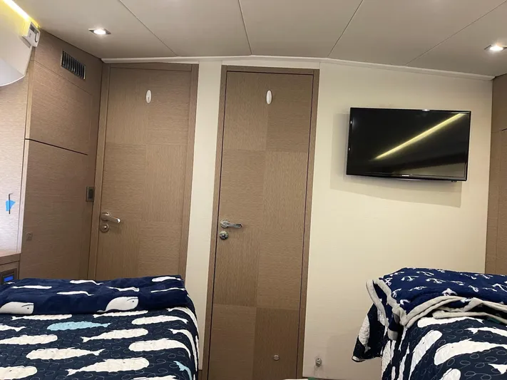  Yacht Photos Pics Interior of 2018 Prestige 500 S yacht with twin beds and wall-mounted TV.
