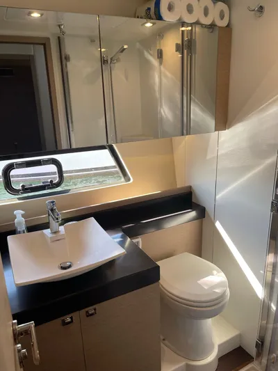  Yacht Photos Pics Modern bathroom in 2018 Prestige 500 S yacht with sink, toilet, and mirrored cabinets.
