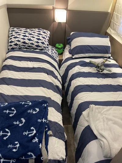  Yacht Photos Pics Nautical-themed twin beds in a 2018 Prestige 500 S yacht cabin.