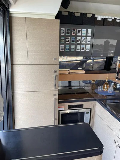  Yacht Photos Pics Modern kitchen interior in a 2018 Prestige 500 S yacht, featuring sleek cabinetry and appliances.