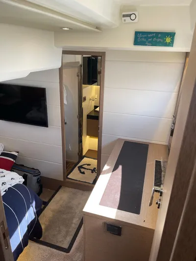  Yacht Photos Pics Interior of a 2018 Prestige 500 S yacht, featuring a cozy bedroom and modern bathroom.