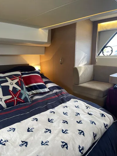  Yacht Photos Pics Luxurious interior of a 2018 Prestige 500 S yacht with nautical-themed bedding.