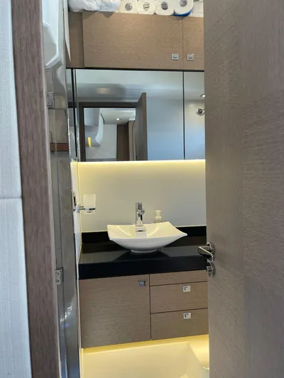  Yacht Photos Pics Modern bathroom interior on 2018 Prestige 500 S yacht, featuring sleek sink and ambient lighting.