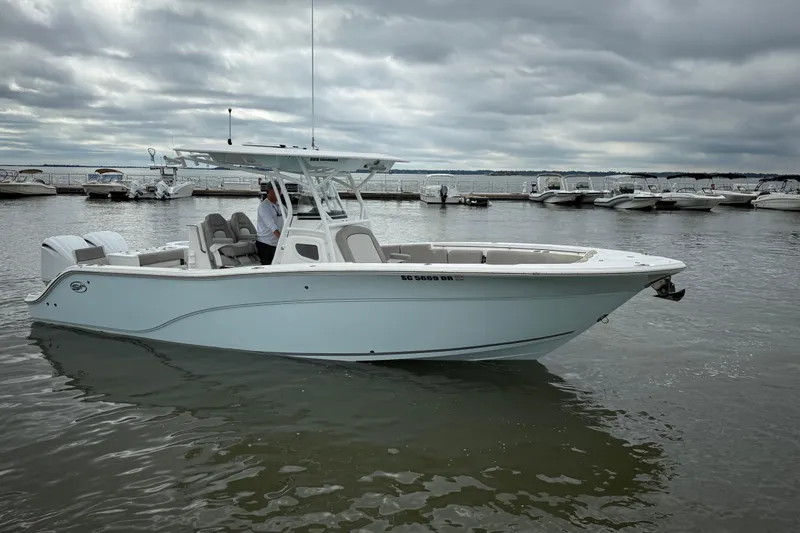  Yacht Photos Pics 2022 Sea Fox 288 Commander boat on calm water, cloudy sky background.