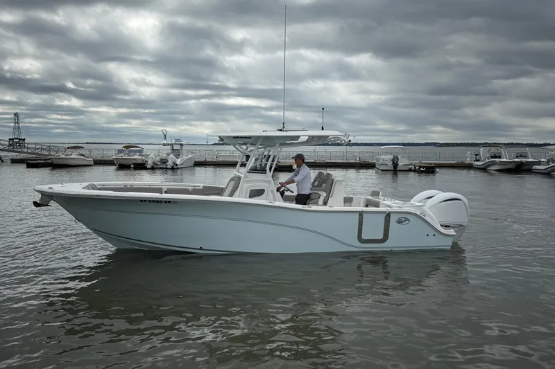  Yacht Photos Pics 2022 Sea Fox 288 Commander boat on water, cloudy sky, marina background.
