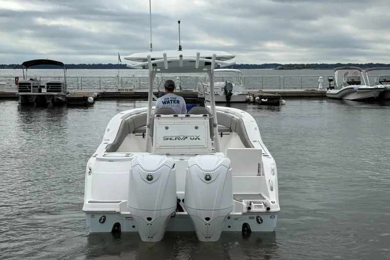  Yacht Photos Pics 2022 Sea Fox 288 Commander boat docked with twin engines, overcast sky.