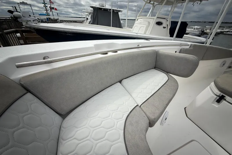  Yacht Photos Pics 2022 Sea Fox 288 Commander boat with cushioned seating and sleek design at a marina.