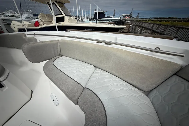  Yacht Photos Pics 2022 Sea Fox 288 Commander boat with cushioned seating in a marina setting.