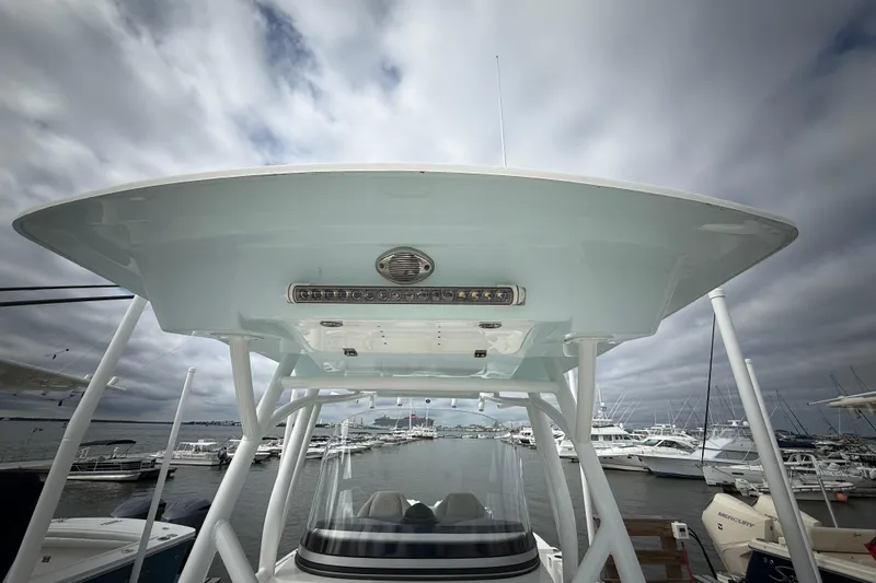  Yacht Photos Pics 2022 Sea Fox 288 Commander boat with T-top, docked at marina under cloudy sky.