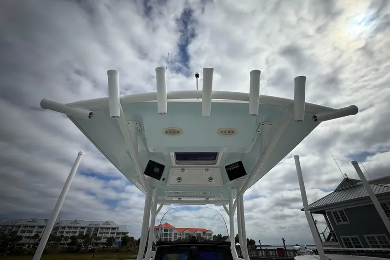  Yacht Photos Pics 2022 Sea Fox 288 Commander boat top view with rod holders under cloudy sky.