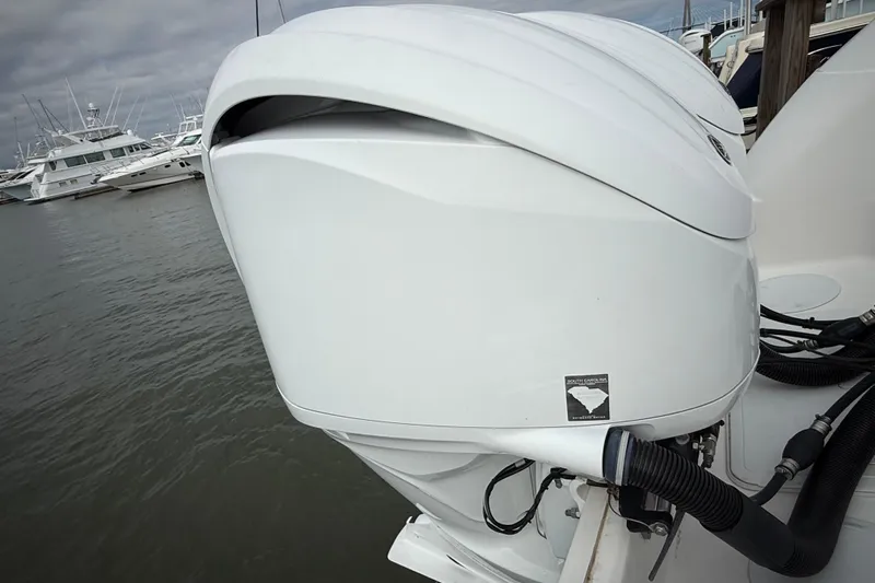  Yacht Photos Pics 2022 Sea Fox 288 Commander boat engine at marina, overcast sky.
