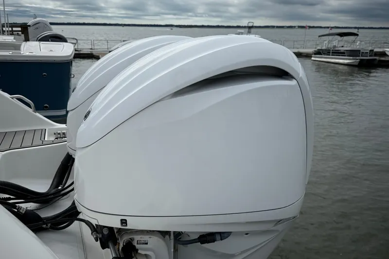  Yacht Photos Pics Twin outboard engines on a 2022 Sea Fox 288 Commander boat docked by the water.