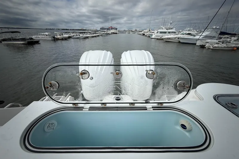  Yacht Photos Pics 2022 Sea Fox 288 Commander boat with twin engines at a marina, cloudy sky.
