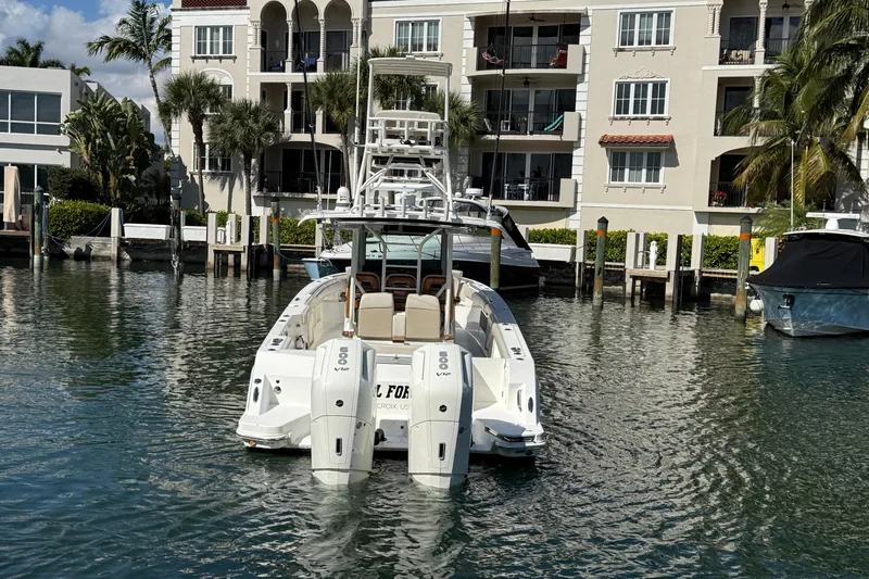 Gail Force Yacht Photos Pics 2023 Boston Whaler 360 Outrage boat docked near waterfront buildings.