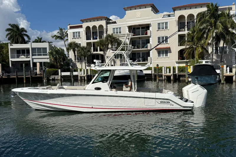 Gail Force Yacht Photos Pics 2023 Boston Whaler 360 Outrage boat docked near waterfront homes.