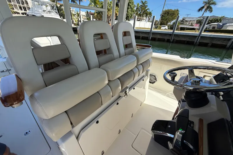 Gail Force Yacht Photos Pics 2023 Boston Whaler 360 Outrage helm with luxurious seating and modern steering wheel.