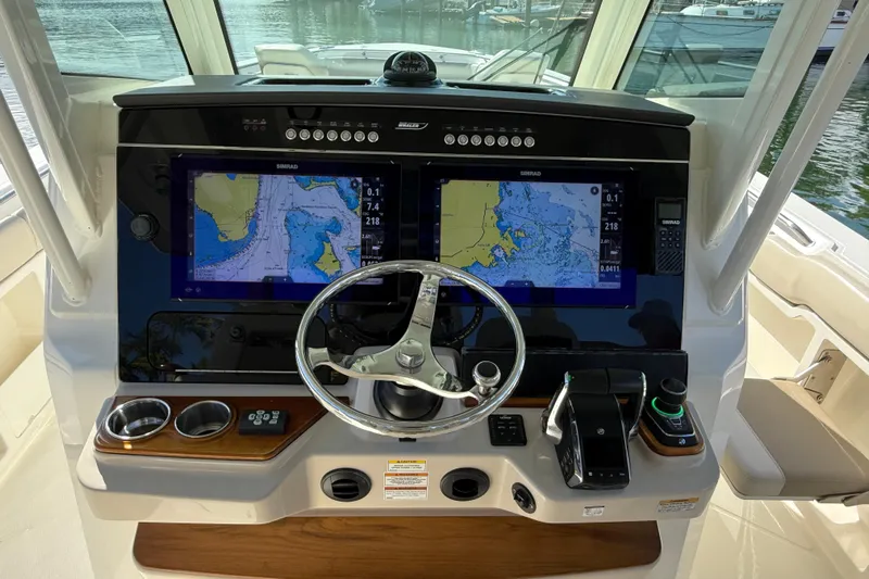 Gail Force Yacht Photos Pics 2023 Boston Whaler 360 Outrage helm with dual navigation screens and steering wheel.