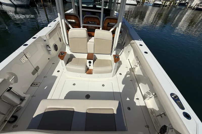 Gail Force Yacht Photos Pics 2023 Boston Whaler 360 Outrage boat interior with seating and cup holders, docked at marina.