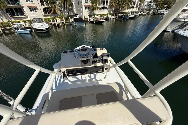 Gail Force Yacht Photos Pics Boston Whaler 360 Outrage 2023 helm overlooking marina with docked boats.