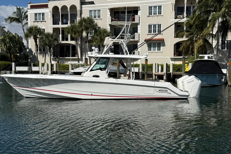 Gail Force Yacht Photos Pics 2023 Boston Whaler 360 Outrage boat docked near waterfront apartments.