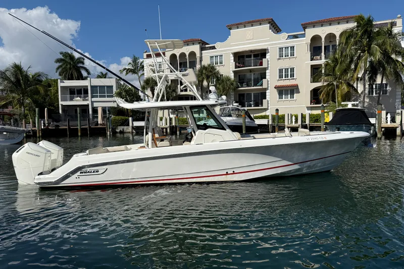 Gail Force Yacht Photos Pics 2023 Boston Whaler 360 Outrage boat docked near waterfront buildings.