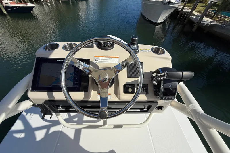 Gail Force Yacht Photos Pics Helm of 2023 Boston Whaler 360 Outrage with steering wheel and navigation controls.